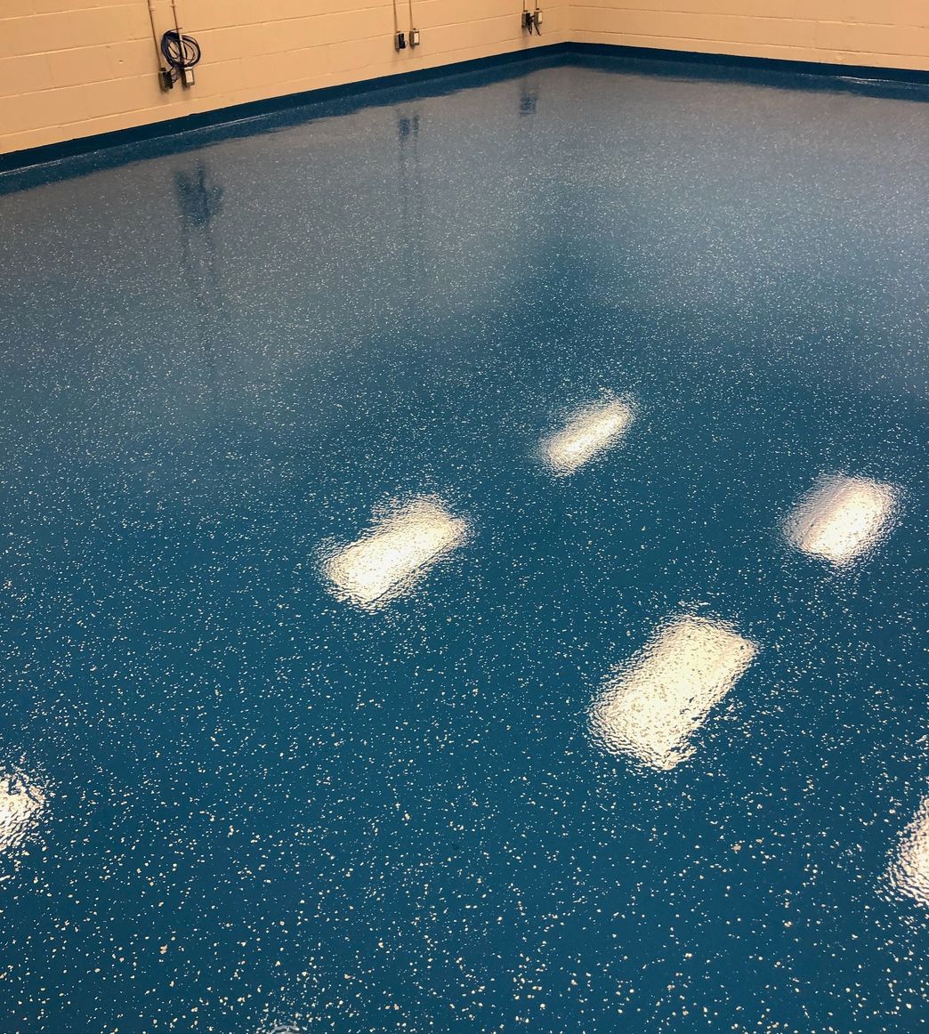 Blue decorative
        epoxy flooring with flakes