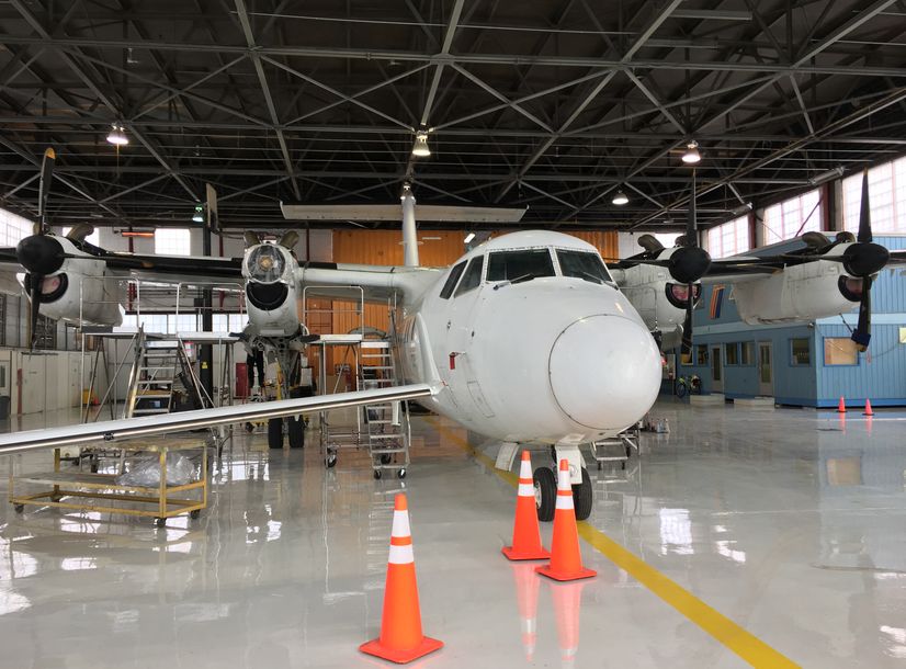 Gray epoxy floors
          in hanger with airplane ontop