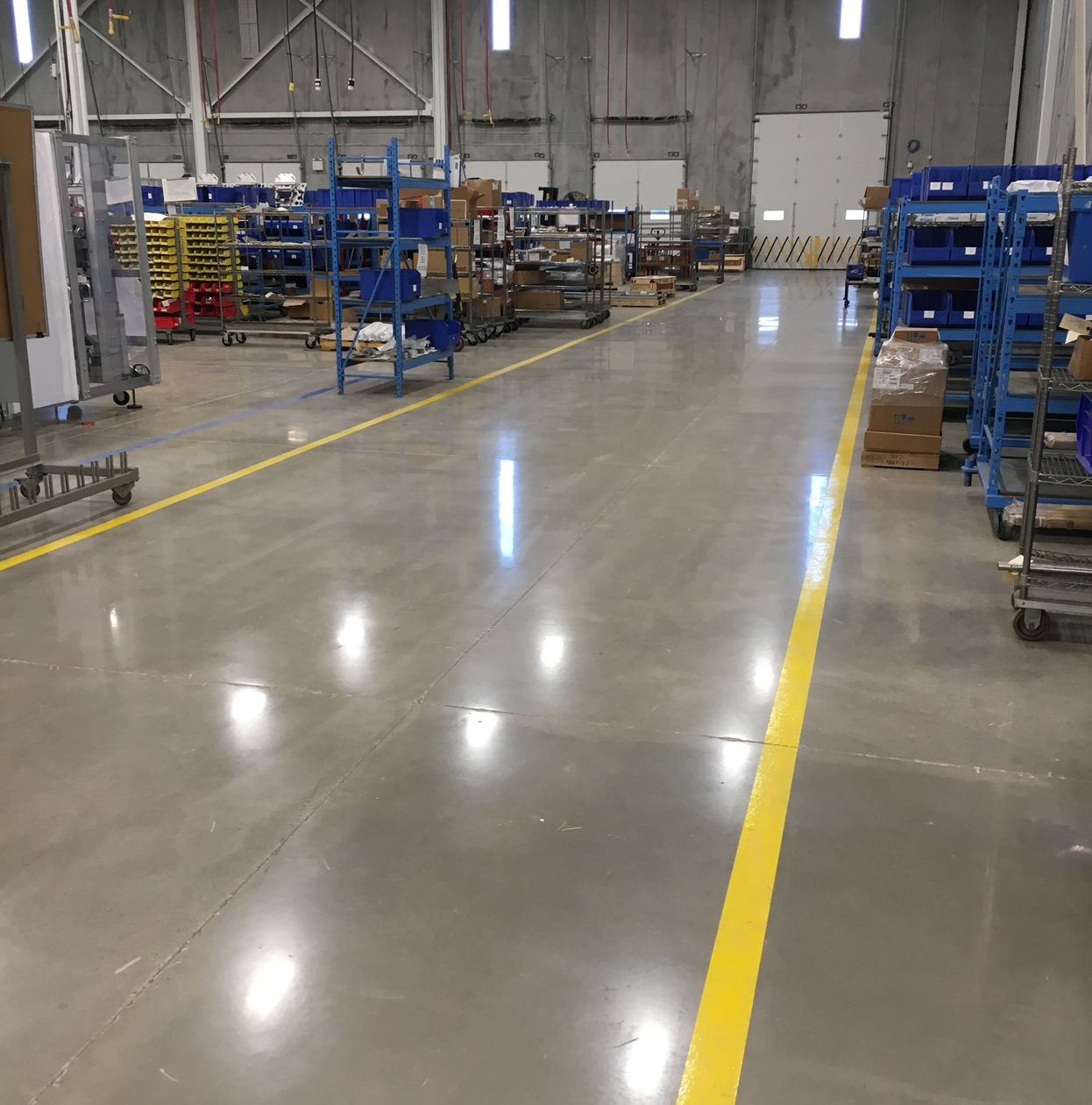 Industrial
        warehouse polished concrete and safety lines